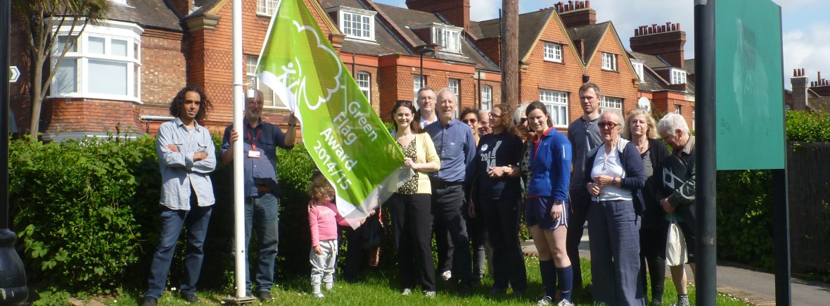 photo of friends and the green flag being raised